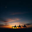 © Md Rifat - Silhouetted camels and riders journey across the desert at sunset