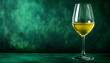 © wolfelarry - Glass of chilled white wine rests on a textured green table. The drink clarity and color are evident against a dark green backdrop, suggesting a sophisticated beverage moment