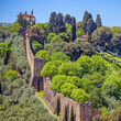© Dimitrios - Forte di Belvedere and its walls sitting atop a hill, encircled by lush greenery and trees, blending medieval architecture with a picturesque landscape. Medici district of Florence, Italy.
