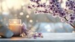 © Yuliia - Serene wellness scene with glowing candle, amethyst crystals, and blooming cherry blossom branch on white wooden surface against soft bokeh background.