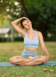 © JackF - Adult woman doing yoga lotus pose on mat in park