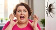 © Evarelle - Terrified woman screaming in fear at a large spider on the wall. Arachnophobia and pest phobia concept