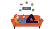 © Muhammad - Man pays for purchases using smartphone while relaxing on couch