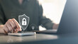 © Garun Studios - cybersecurity, security, A person using a mobile device with a digital lock shield icon, representing cybersecurity, data protection, encryption, and secure access in modern digital environments.