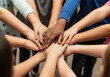 © Habiba - Diverse group of childrens hands stacked together in a circle, symbolizing unity, teamwork, friendship, and cooperation among young people