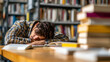 © timurlan999 - Male student sleeping on books in library