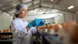 © photostockatinat - Egg sorting: A worker in protective gear carefully examines eggs, meticulously ensuring quality control within a food processing facility. A glimpse into the importance of food safety and hygiene.