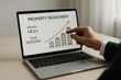 © ParinApril - Business professional analyzing property investment data on a laptop screen, illustrating trends in growth and value in real estate. Concept of finance, investment strategies, and economic analysis.