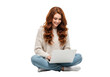 © 3D render png - A young woman with long auburn hair sits cross legged on the floor with a laptop smiling and looking down at the screen isolated on transparent background