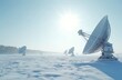© miss irine - Satellite dishes in snow covered field. Winter landscape with communication towers under bright sun. Radio antennae array connected to global network on frosty day.