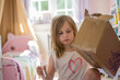 © Westend61 - Child painting and decorating a cardboard box in her bedroom