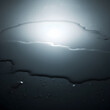 © Sergii - Water spill creating abstract wet surface reflection