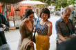 © TrueShot | Westend61 - Friends shopping at an outdoor flea market