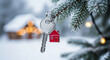 © PhotoArtHub - Silver key with a red house pendant on a frosted pine branch, symbolizing new beginning, property or real estate purchase during the winter season