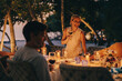 © Jacob Lund - Family enjoying dinner with smiling matriarch at island resort