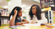 © Abrahams66/peopleimages.com - Teacher, student and lesson with books in library with reading evaluation, literature and problem solving. Tutor, child and education with help for assessment, learning support or study assistance