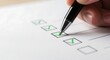 © Sahnaj - Closeup of a hand holding a pen and marking a checkbox on a white paper with a green checkmark, signifying completion or agreement