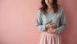 © Pete - Young woman suffers from stomach pain. Female feels unwell. She is holding her belly. The girl has health issues, digestive problems or painful menstruation. Woman in skirt on pink backdrop.