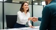 © Ummu MMM - Smiling businesswoman sealing deal with handshake during successful meeting