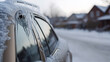 © photo for everything - Icy car on a snowy street. Winter's grip is evident as icicles hang from the car's roof, capturing the harsh beauty of a frozen landscape with houses in the background.