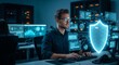© ANDREY PROFOTO - Cybersecurity analyst monitoring data protection with digital shield in server room