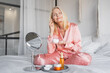 © InsideCreativeHouse - Home and female person with application for cosmetics, beauty treatment and face moisturizer. Skincare, portrait and adult woman with cream in bedroom, wellness and anti aging benefits in morning.