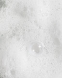Macro texture photo of white foamy soapy bubbles