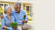 © ArtMajestic - Senior Caucasian couple gardening together, smiling and looking at each other. Happy retirement lifestyle and outdoor leisure activity banner with copy space