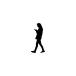© Farhan - Stylish silhouette of a woman checking her phone while walking, modern lifestyle and connection concept
