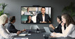 © fizkes - Diverse businesspeople participate in videocall, displayed on tv screen