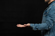 © Alejandro Bernal - a man wearing a denim jacket ready to hold something on space with his hand