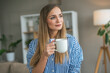 © Miljan Živković - Beautiful woman drink coffee and enjoy at her living room