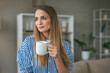 © Miljan Živković - Beautiful woman drink coffee and enjoy at her living room