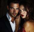 © Donna - Elegant couple in evening attire sharing an intimate romantic moment, woman in red sequined off-shoulder dress touches man in black suit with open white shirt in warm glamorous light