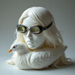 © istudio - White porcelain mannequin head wearing vintage goggles on a sculpted white duck body