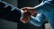 © PrabuanaAndika - Close-up of two businessmen shaking hands finalizing a corporate deal or agreement.