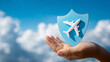 © Atchariya63 - Airplane travel insurance protection safety shield sky cloud hand security start sentence calm and confident, promoting peace of mind for flight