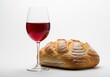 © Vooglo.com - Loaf of bread and glass of red wine isolated on white background, symbolizing communion, eucharist, or the last supper in christian tradition