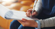 © SiphosethuFan/peopleimages.com - Nurse, hands and writing with documents for medical prescription or diagnosis in home. Closeup, caregiver or taking notes with clipboard for medication checklist, patient history or health insurance