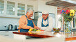 © peopleimages.com - Senior couple, cooking and vegetables in kitchen, happy and discussion with nutrition in retirement. Elderly woman, man and organic produce with meal prep, ingredients or smile with chat at apartment