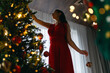 © Konstantin Yuganov - woman near Christmas tree indoor