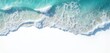 © Maryna - Aerial photo of ocean waves crashing onto a white beach. Turquoise water creates a beautiful pattern. Natural beach texture with foam and water edge. Peaceful summer seaside view.