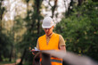 © Ljustina - Forest engineer inspecting plans for construction project in park