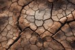 © juliars - Dry cracked earth representing drought, climate change, and desertification