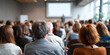 © perfectlab - Audience attending a professional seminar or conference in a modern meeting room with speakers presenting on a screen
