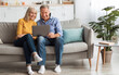 © Prostock-studio - Cheerful Senior Spouses Using Laptop Watching Movie Online Or Browsing Internet Sitting On Sofa At Home. Older People And Gadgets, Modern Retirement Lifestyle Concept