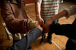 © TrueFrame Collective - Group of multiethnic teenagers joining fists in unity, gymnasium floor background, demonstrating teamwork and collaboration during psychology class activity for students