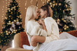 © standret - Love, care conception, sitting together. Mother and daughter are celebrating New Year at home in domestic room