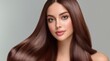 © vilaiporn - Portrait of a young woman with long, shiny brown hair against a neutral background, showcasing beauty and elegance.