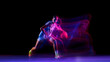 © master1305 - Female basketball player dribbling with ball in glowing studio motion. Concept of fitness promotion, motivation visuals, sports branding, and energetic lifestyle ads.